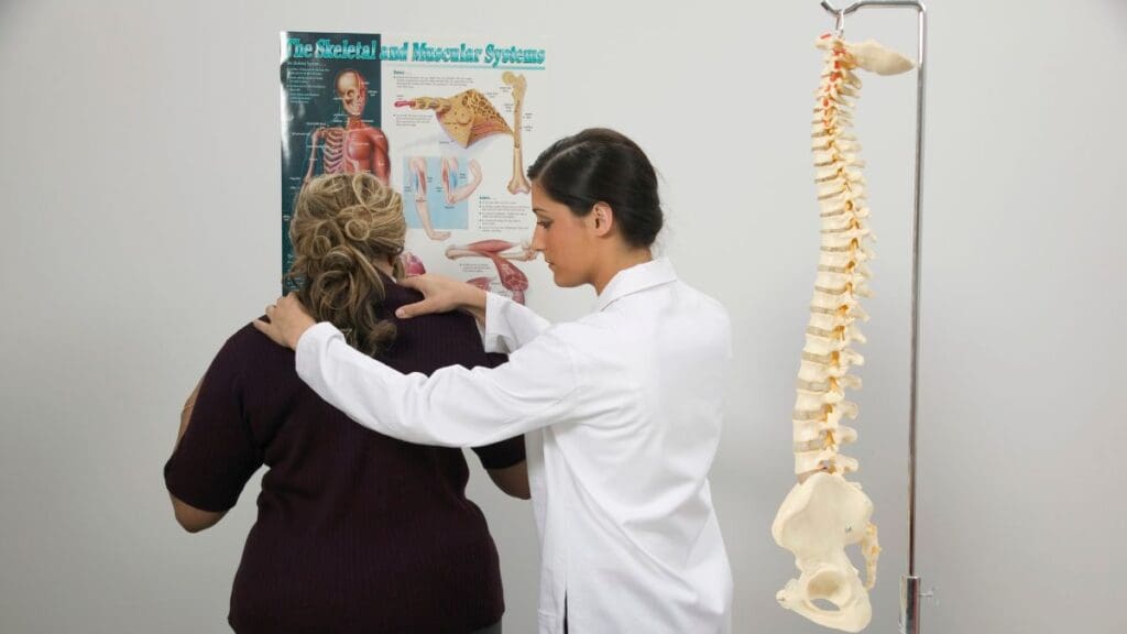 Doctor Examining A Patient's Back
