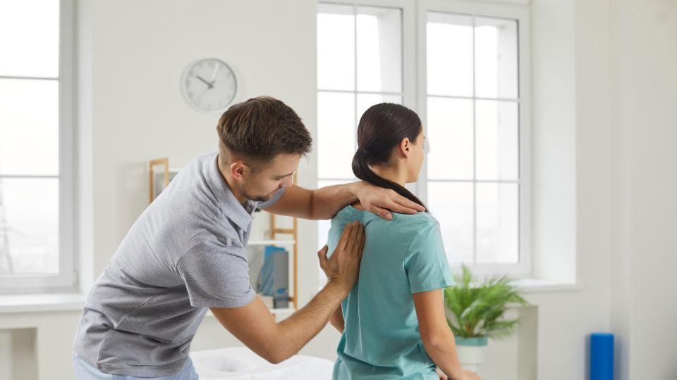 A Chiropractor Adjusting A Patient's Back