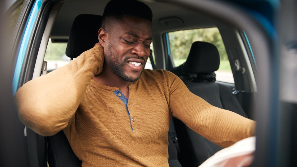 Man Experiencing Neck Pain In A Car